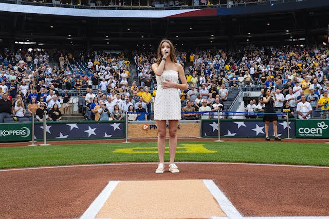 Cat Tedder singing the national anthem at home plate at a Pittsburgh Pirates game